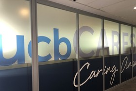 Wall with UCBCares printed on glass windows
