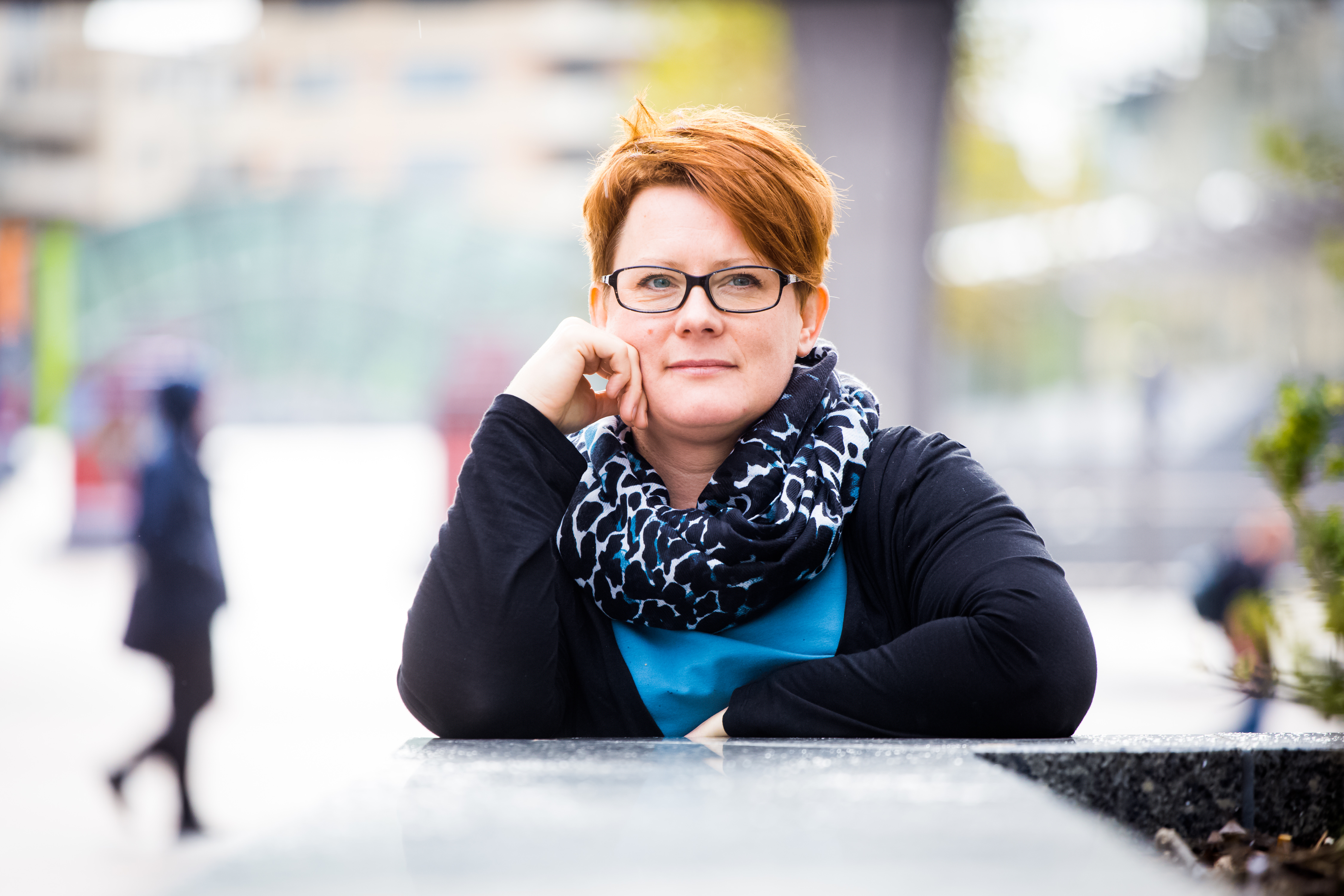 Patient in glasses leans against ledge