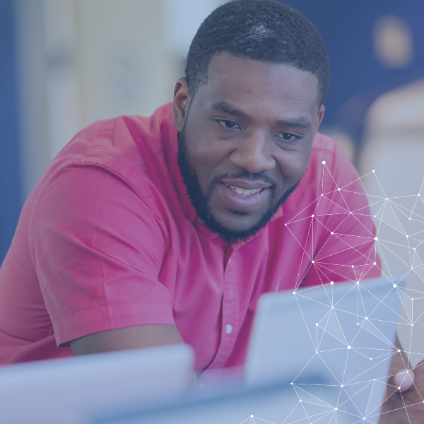 Person in pink shirt engaged with computer screen