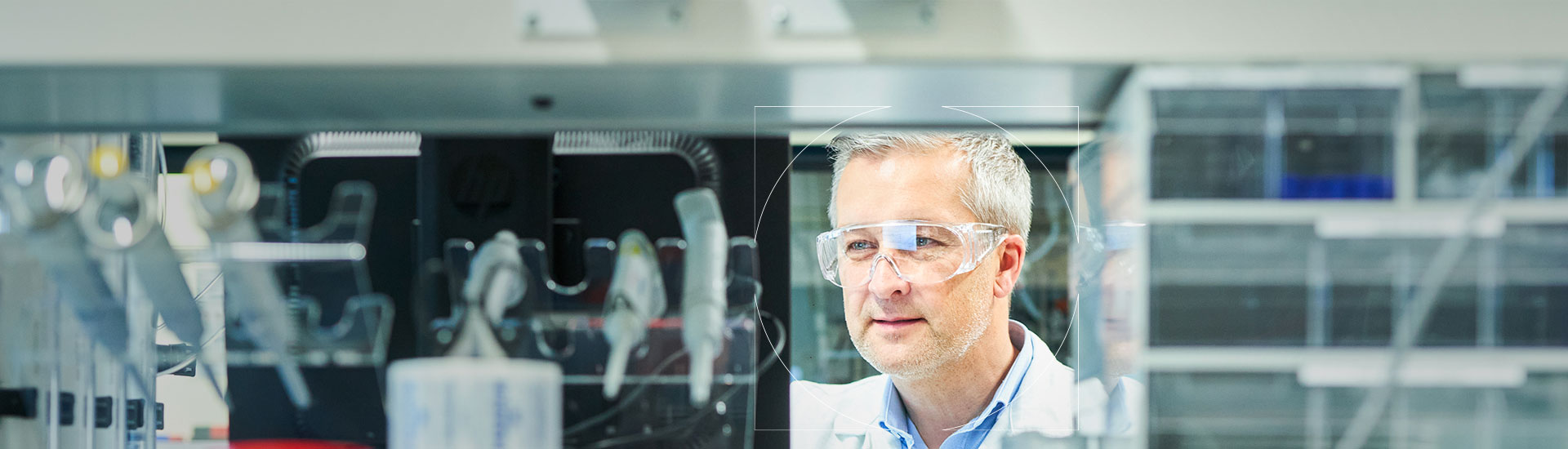 UCB scientist in goggles looking at a computer